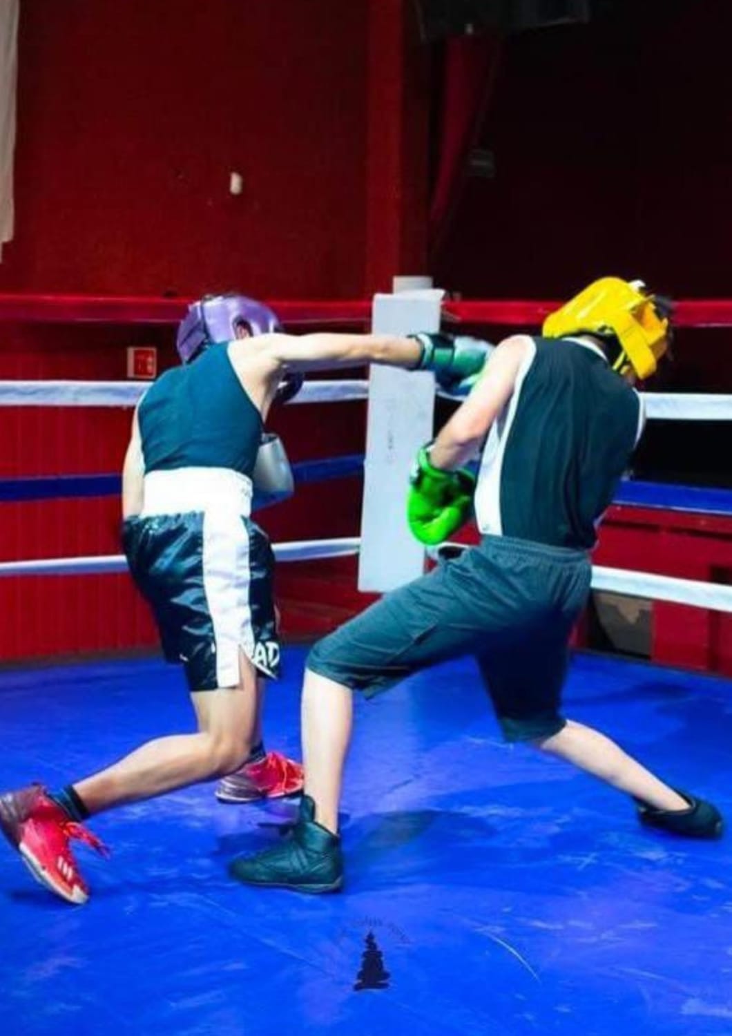 Boxing students practicing technique in the ring